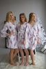 Dusty mauve and gold bridesmaids wedding robes in feather print
