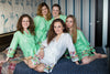 Bridesmaids and the bride in mint and white bird themed getting ready robes