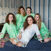 Bridesmaids and the bride in mint and white bird themed getting ready robes